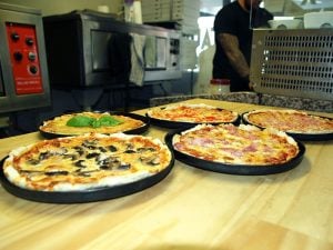 Image of Minos Pizzas hot out of the oven.